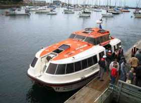 cruise ship Tendor docked  in phuket with happy tourists embarking from day tour shore excursions
